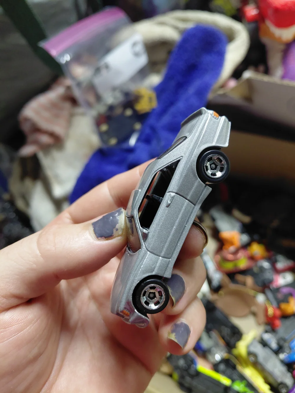 1:64 scale Hot Wheels '89 Mercedes-Benz 560 SEC AMG die-cast toy car.